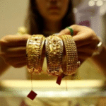 Gold edges lower on stronger dollar, Fed minutes weigh on rate-cut hopes Business